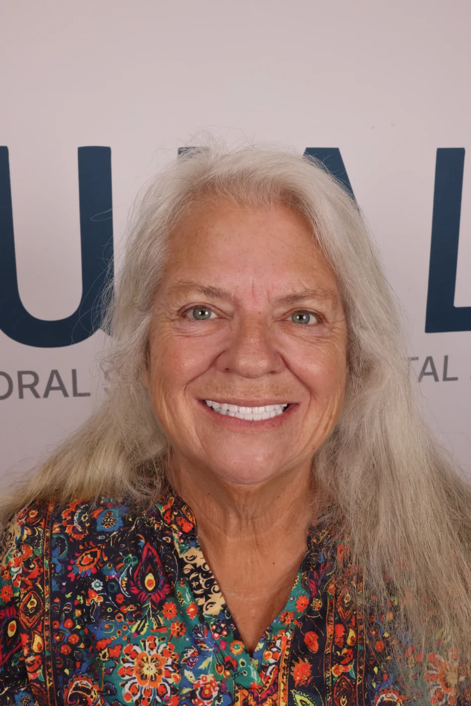 Patient smile after full-arch dental implant treatment, patient case 01